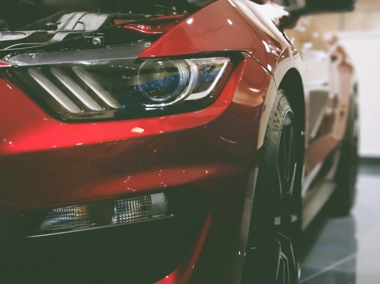 a mustang that is parked inside a garage