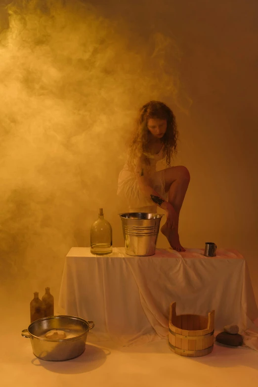 a woman sits on top of a table