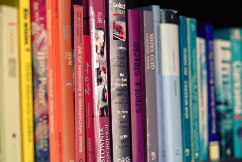 an assortment of books sitting on a book shelf