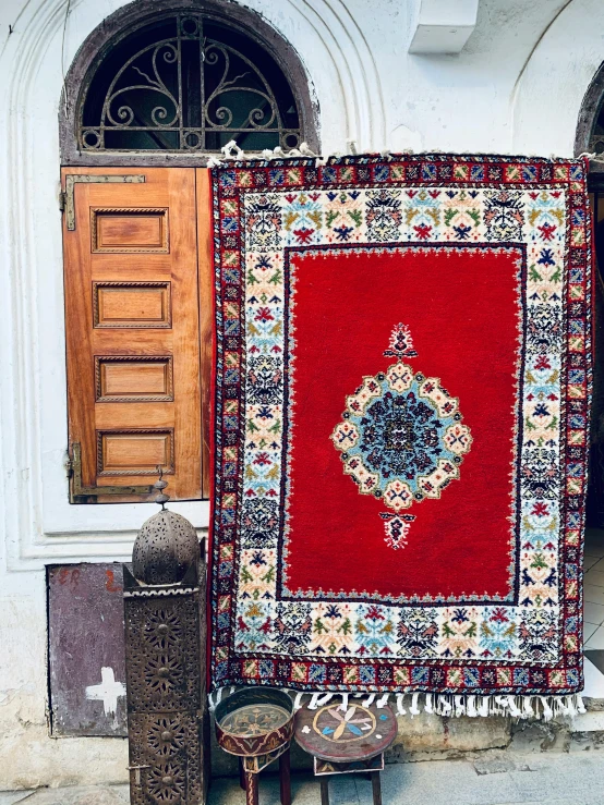 a rug is set up to be hung out in front of a building