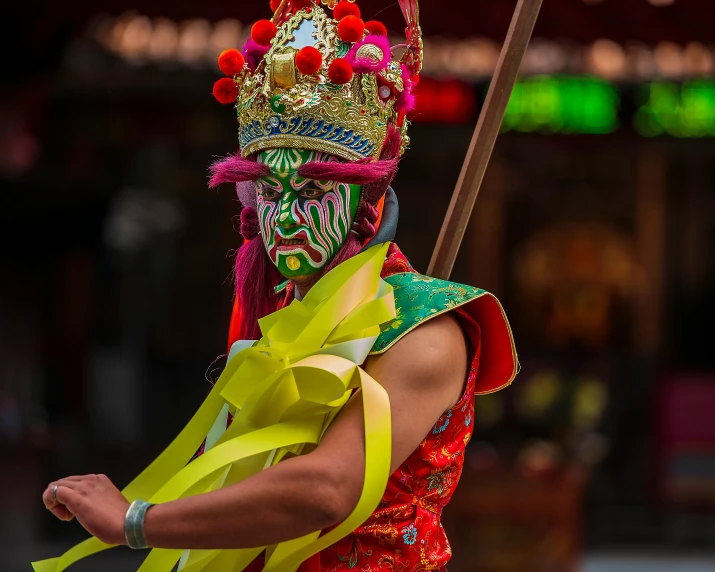 a man in a mask carrying a broom