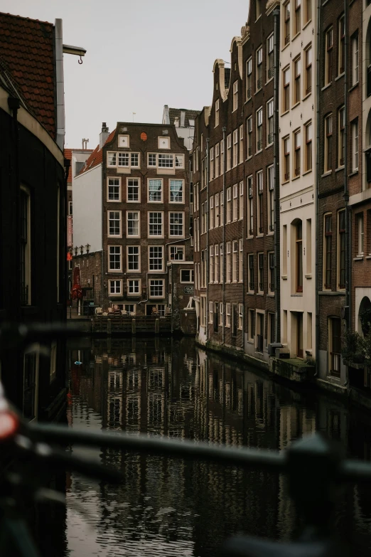 some houses are reflected in the water