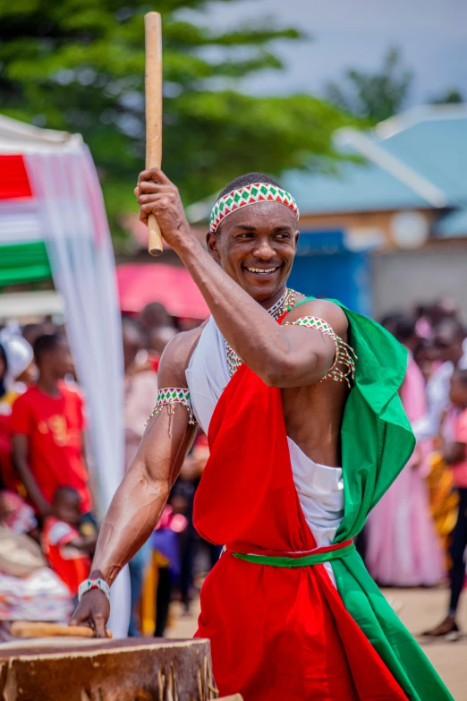 a man dressed in a costume holding an ax and smiling