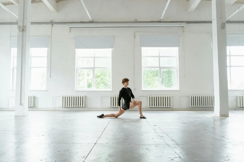 a woman sitting in the middle of an empty room