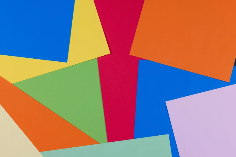 various colored papers arranged together on a white surface