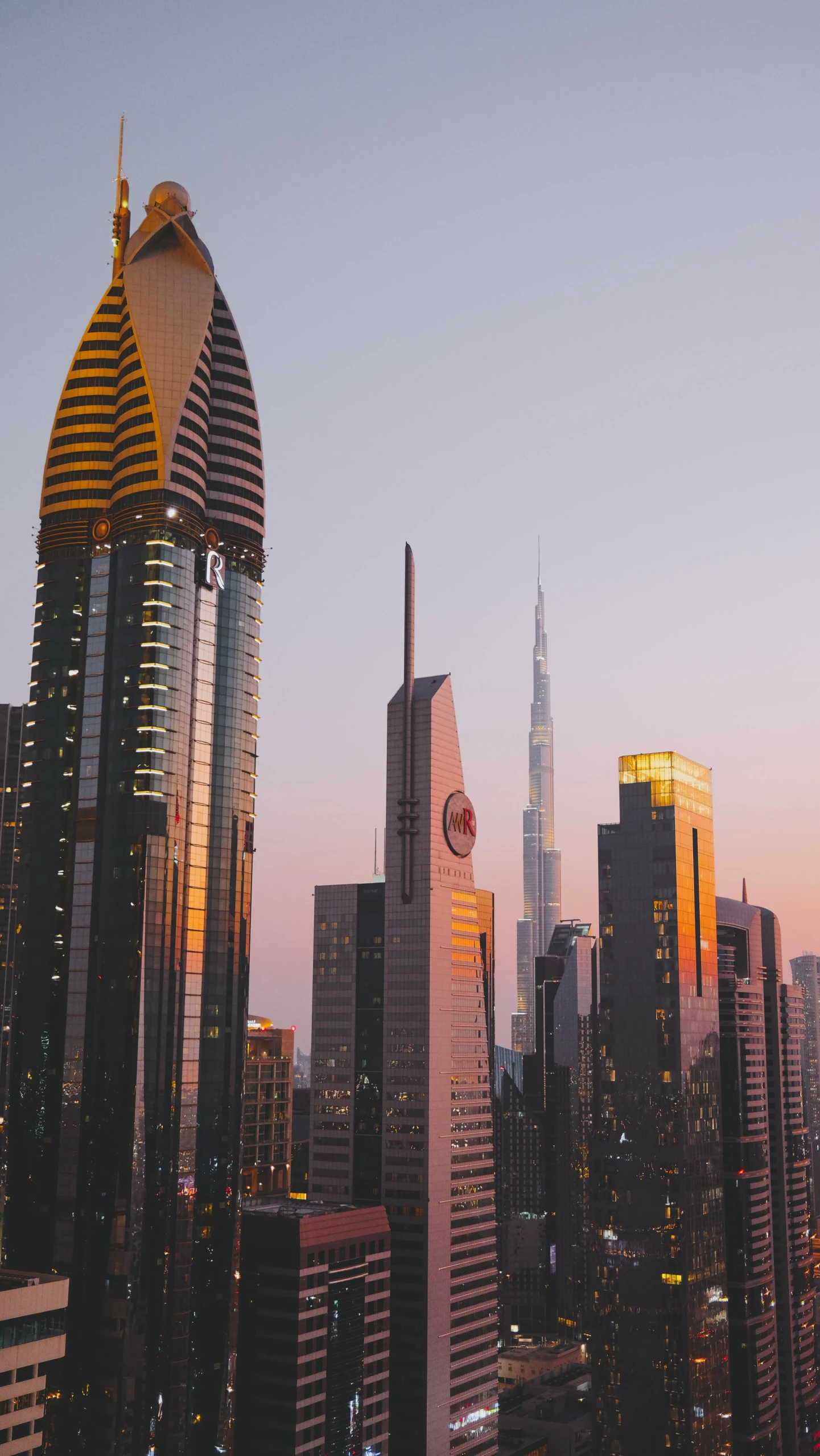 the city skyline is at dusk as buildings stand on both sides