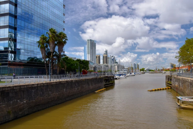 a waterway that runs through a city under cloudy skies