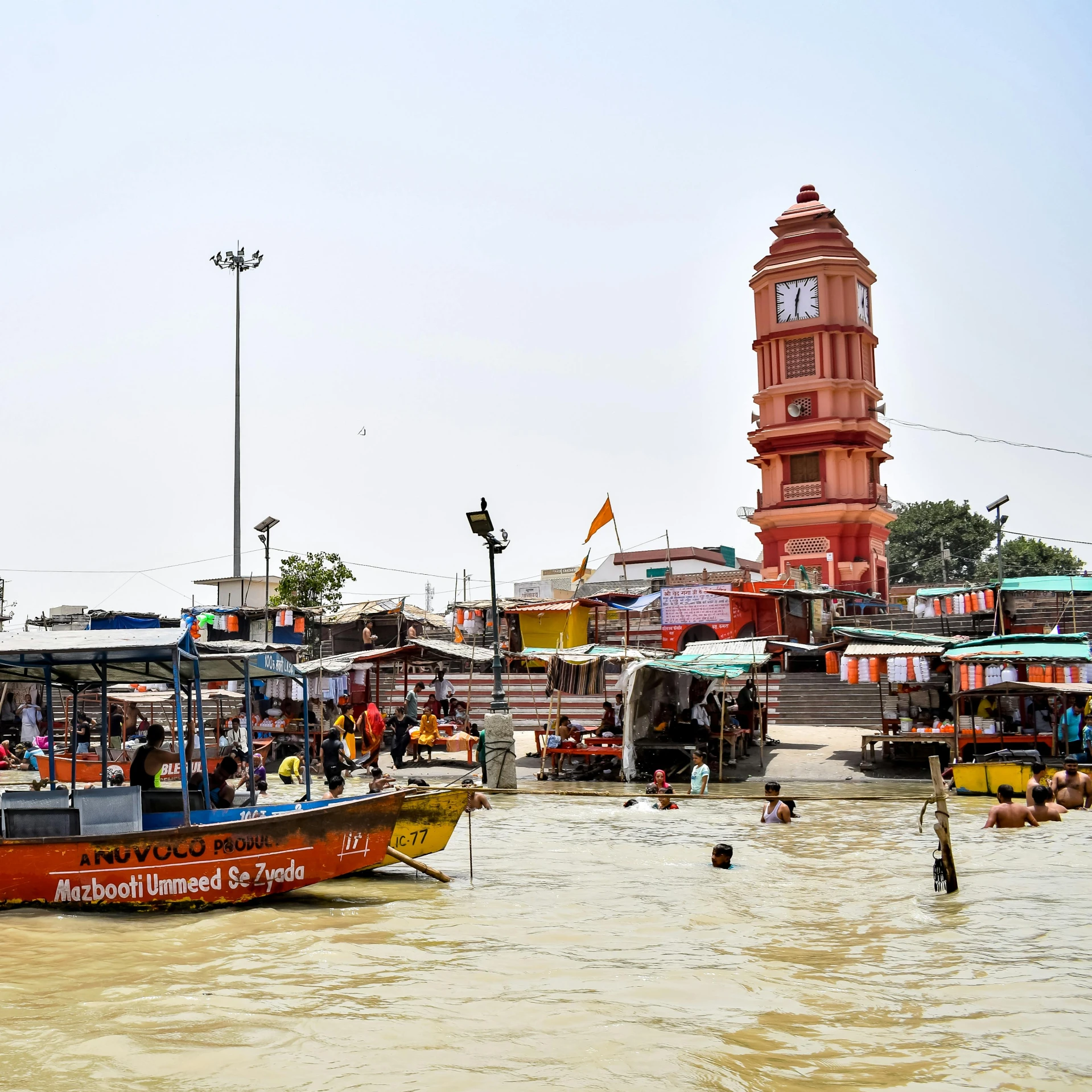 a body of water with boats, people and buildings