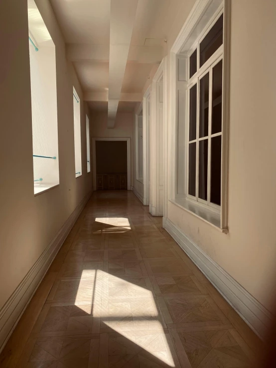 the sun is coming through the windows onto a hallway