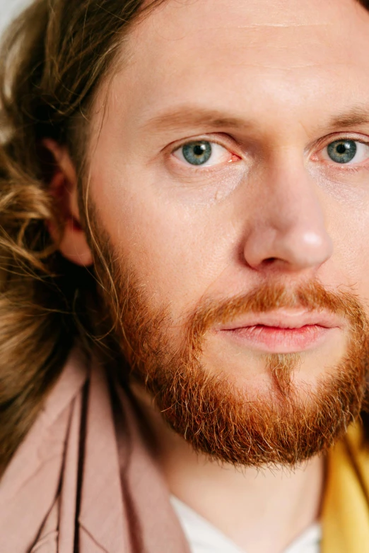 a close up of a young man with long hair