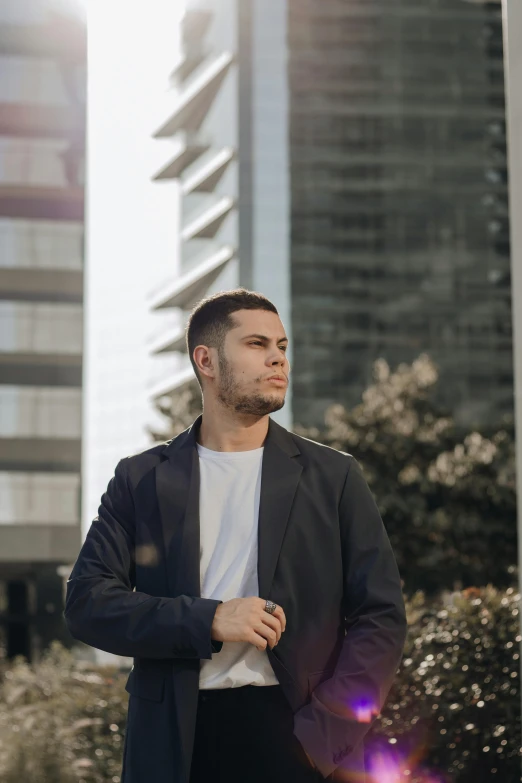 a man standing in front of some tall buildings