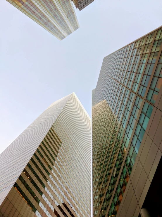 looking up at several different building with some tall buildings