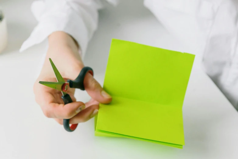 scissors  a piece of paper using green tape