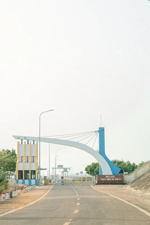 a long concrete bridge over a paved road