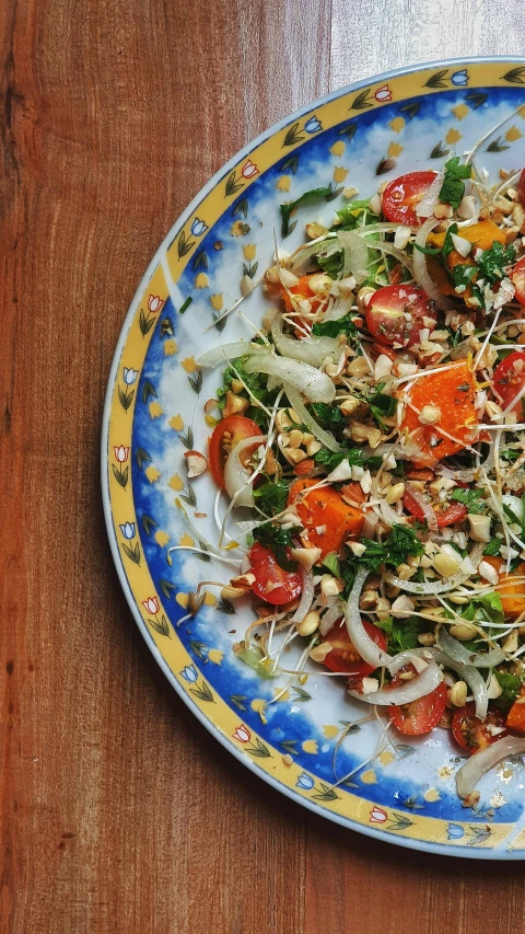 a bowl of salad with tomatoes and other vegetables