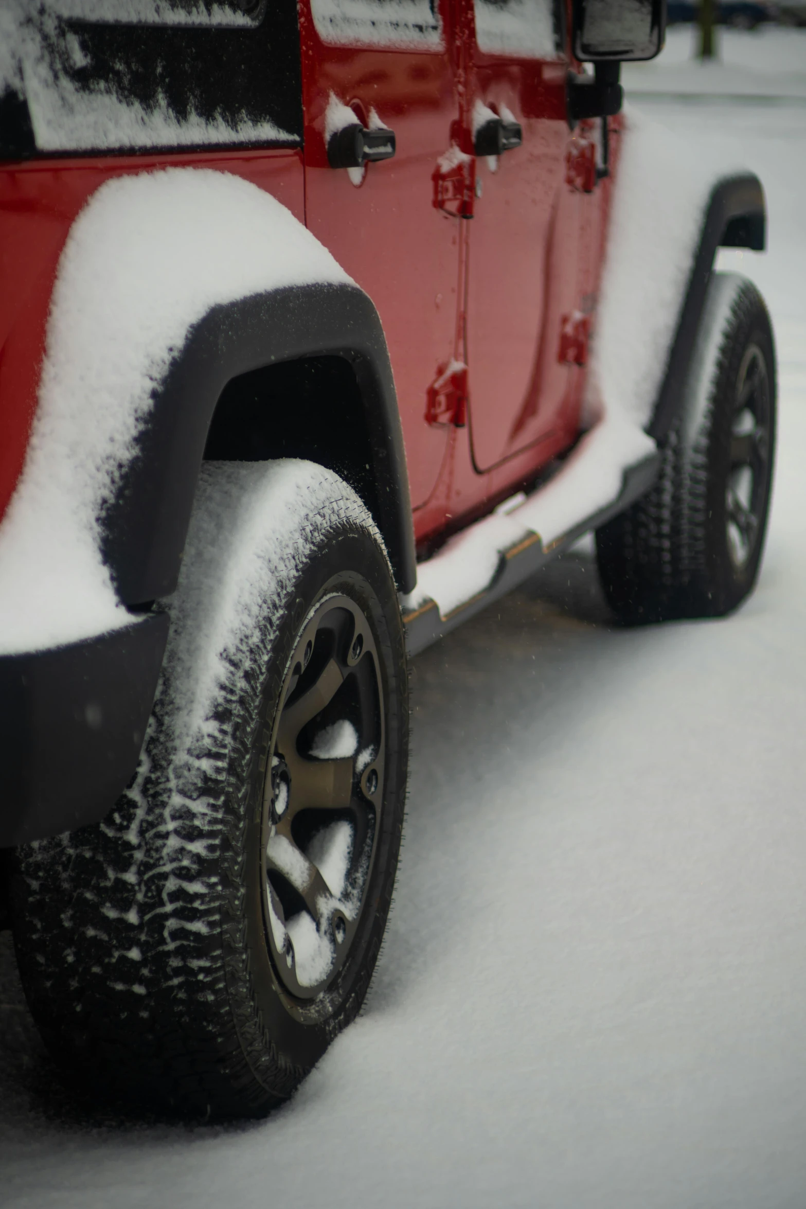 a red truck with some snow on the ground