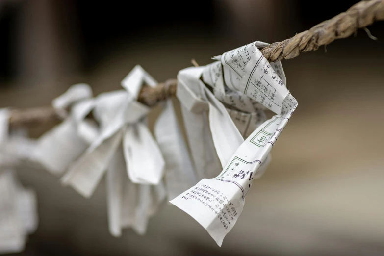 notes pinned onto a cord with a wire