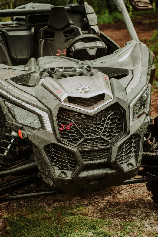 some gray black and red vehicles on some dirt