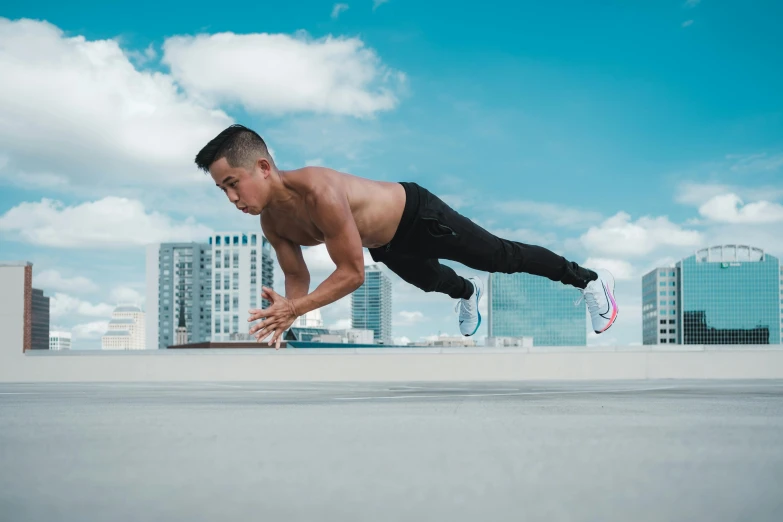 a man in black pants doing a trick on a skateboard