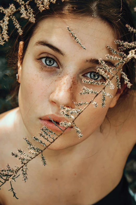 a woman with a floral headpiece posing for the camera