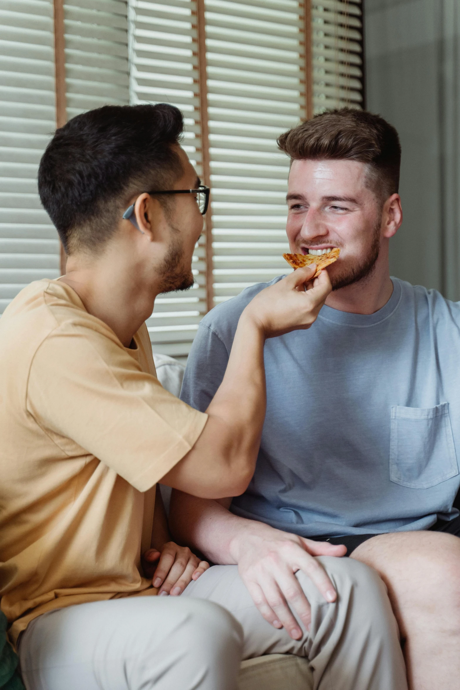 a couple of men are talking and eating food