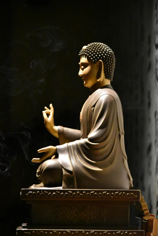 a statue of buddha is sitting on steps