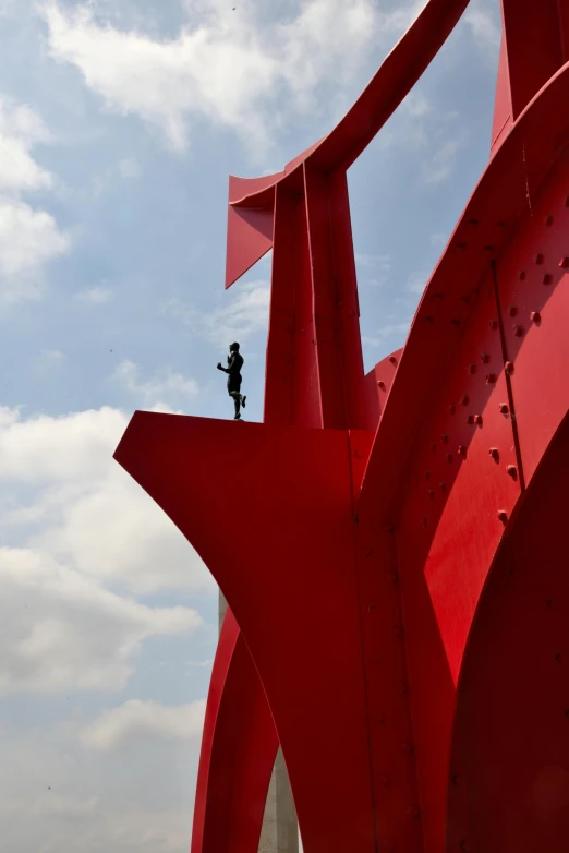 a tall building with a sculpture in front