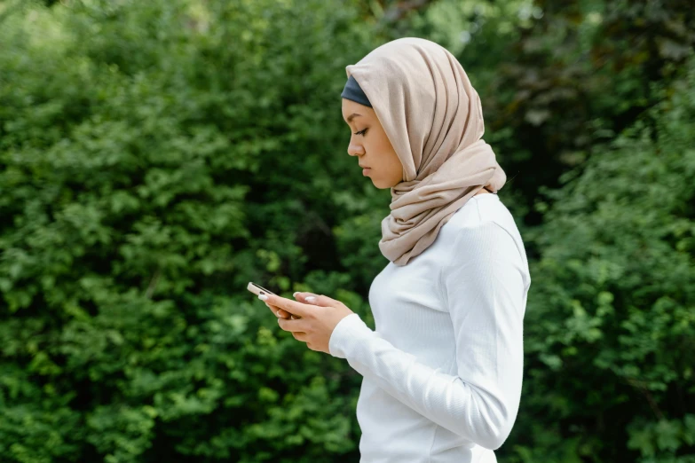 a woman in hijab using a smart phone