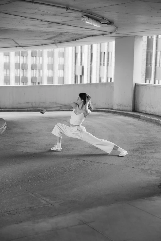 a young woman is practicing in an empty garage