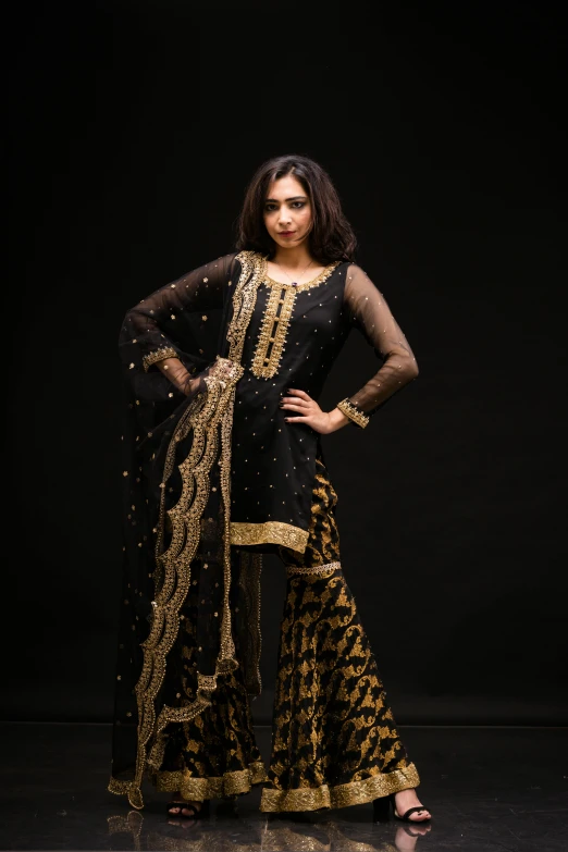 a young woman standing in front of a black background