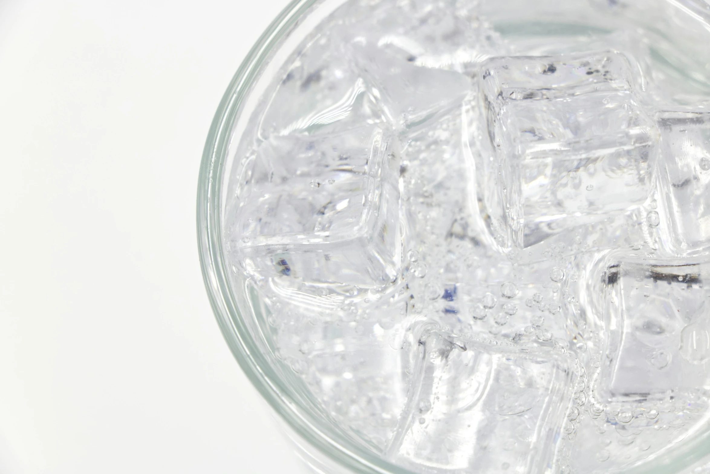 a full drink sits in a clear glass container