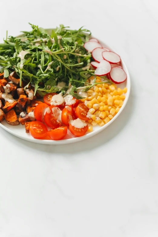 a plate full of vegetables and salad dressing