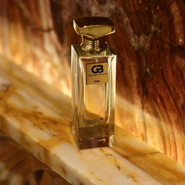 an empty bottle of perfume sitting on a marble counter