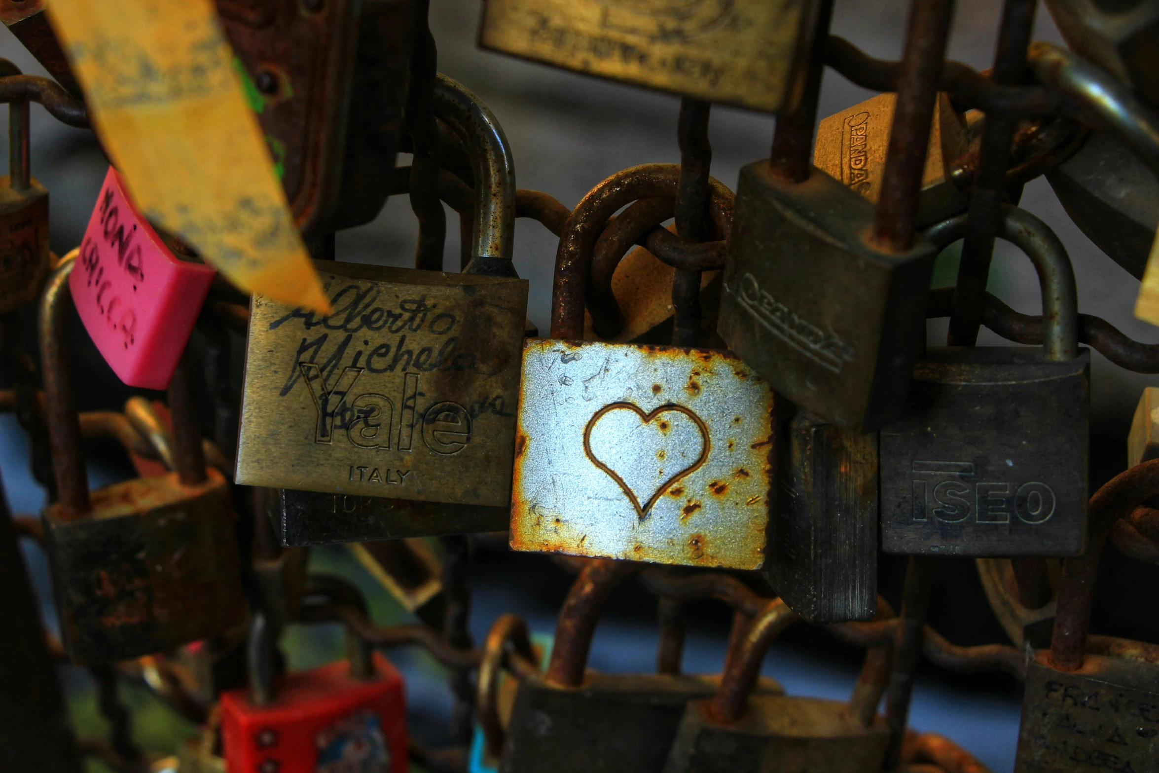 many padlocks with different locks that have been marked with a heart