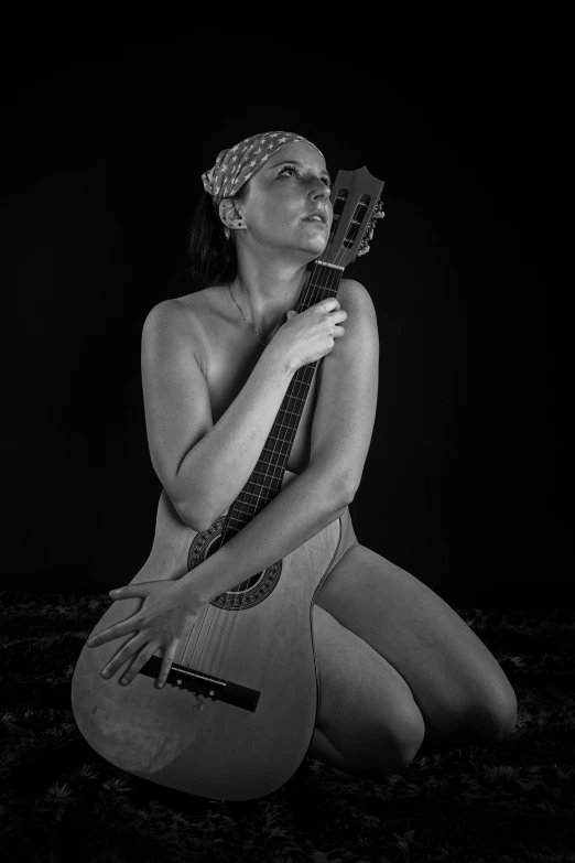 a woman with her guitar in a black and white po