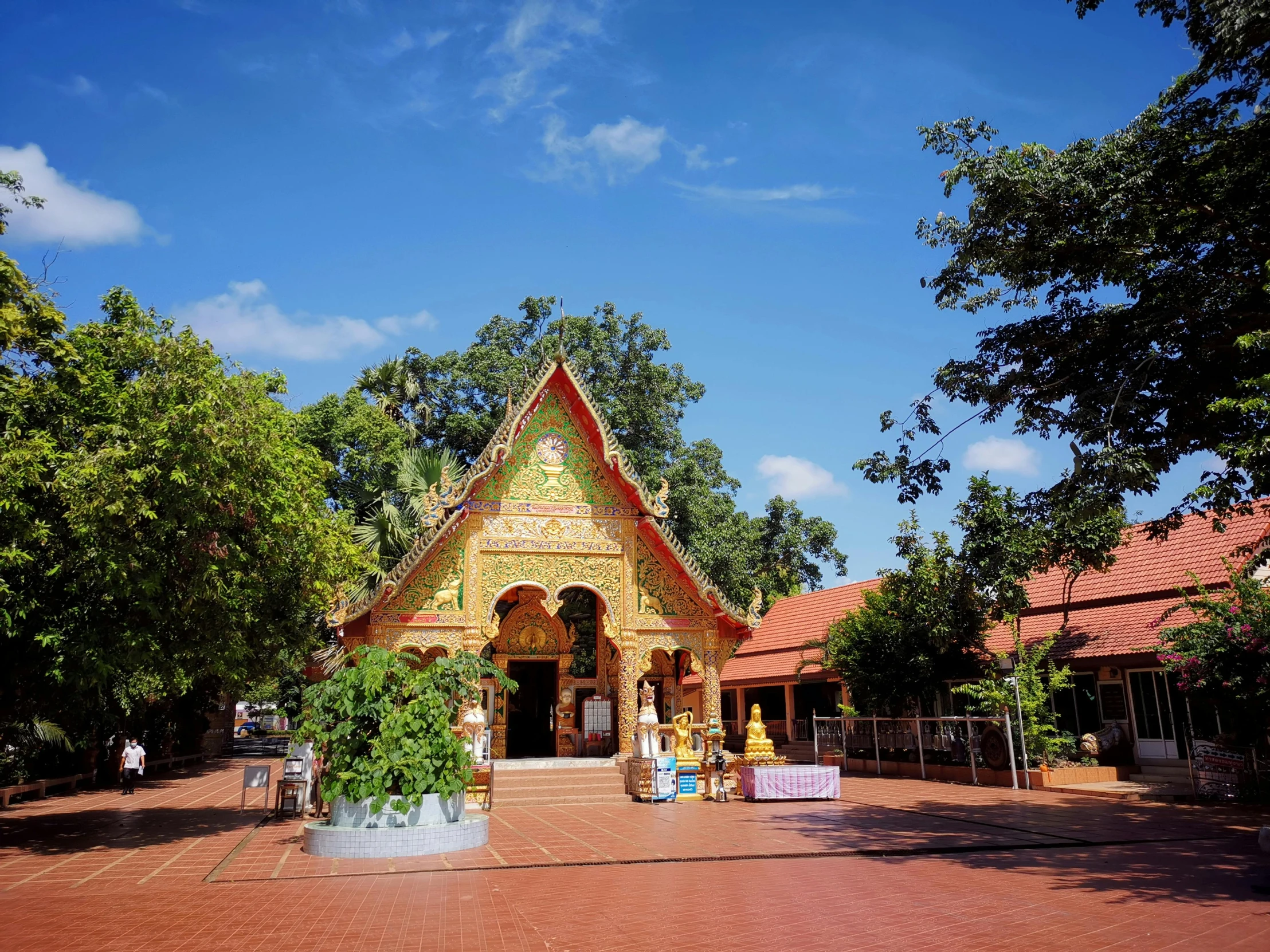 the exterior of a small shrine is shown in front of many trees