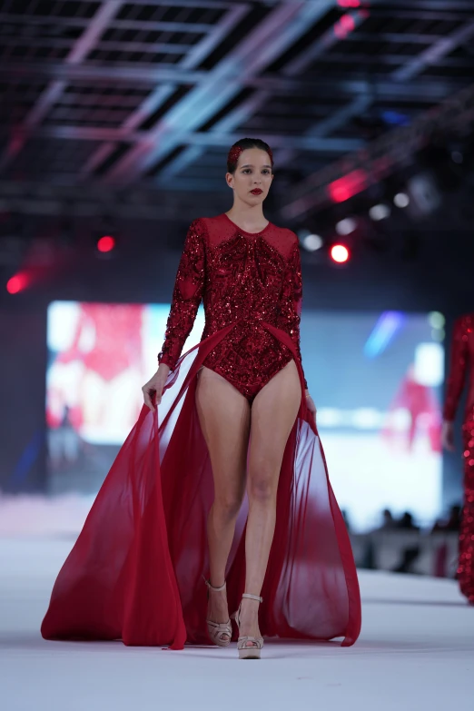 a woman with long legs walking down a runway