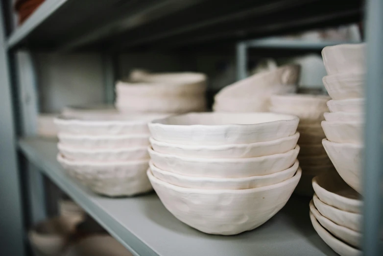 some white plates that are stacked on top of each other