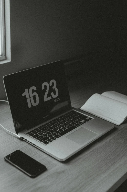 a laptop and cell phone on a desk