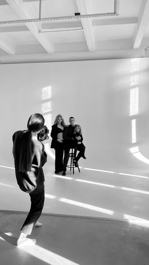 a woman is doing a dance trick in front of a group of women