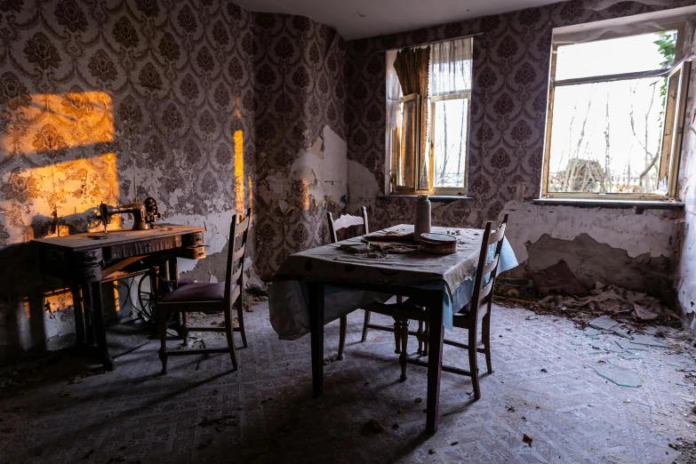 an old dining room with peeling wallpaper and flooring