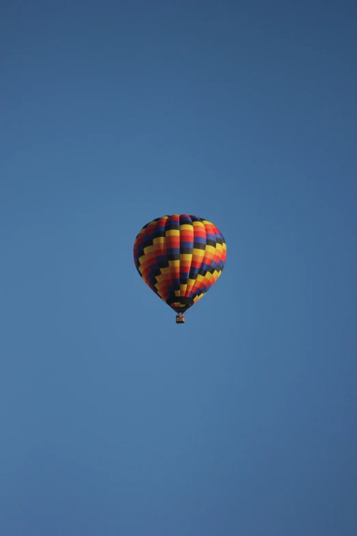 a  air balloon floating through the blue sky