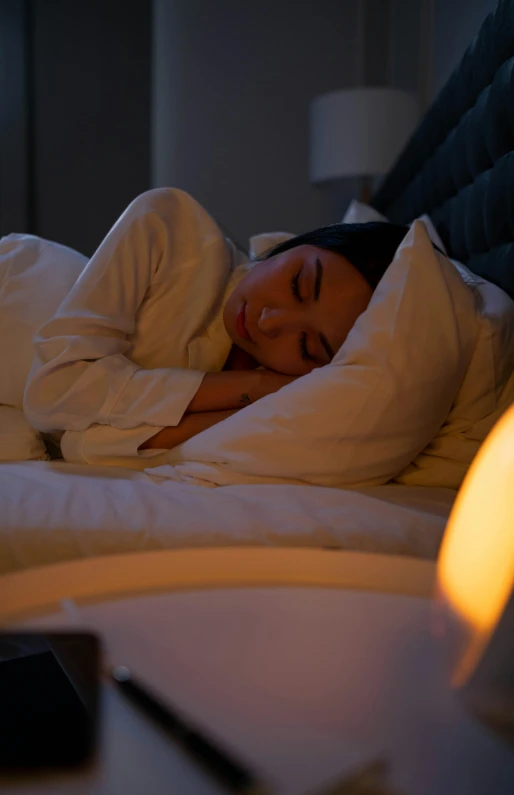 a young lady is sleeping in her bed