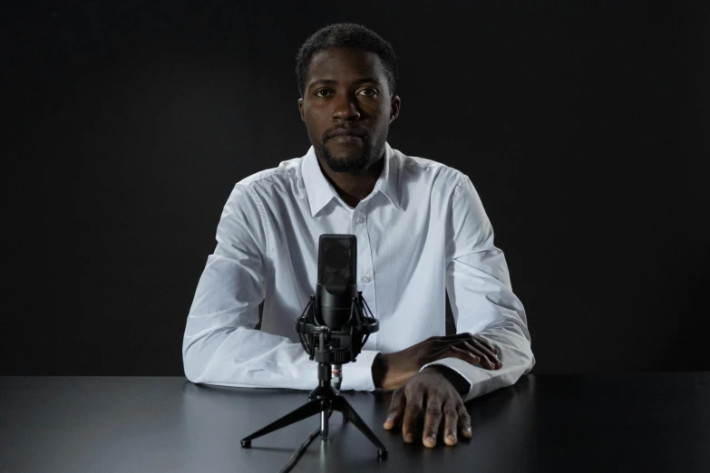 a man is sitting in front of a microphone