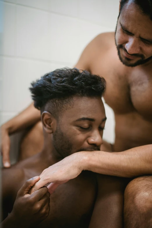 two black men are getting ready to get into the bathroom