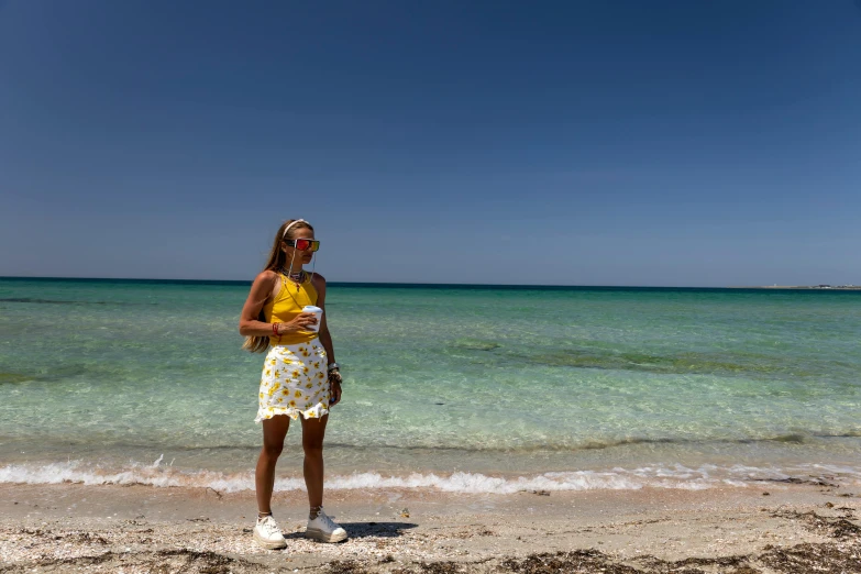 there is a woman standing at the edge of the water