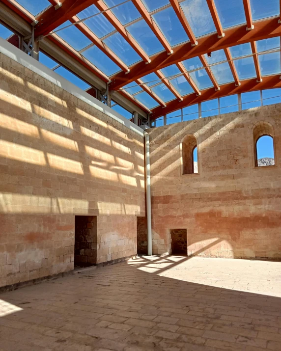 the sun shines down on a large brick building