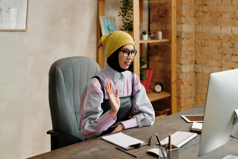 a person sitting at a desk with a computer