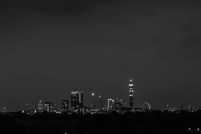 a city skyline at night is seen with its light on