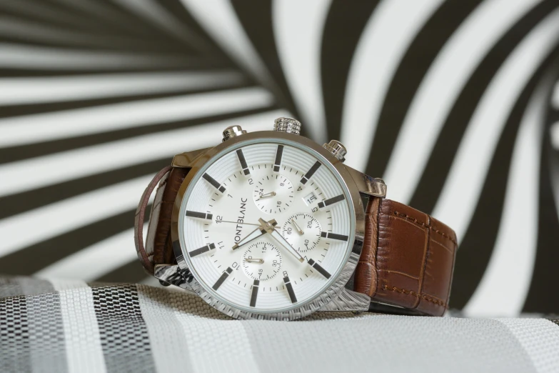 a watch on a table near some black and white walls